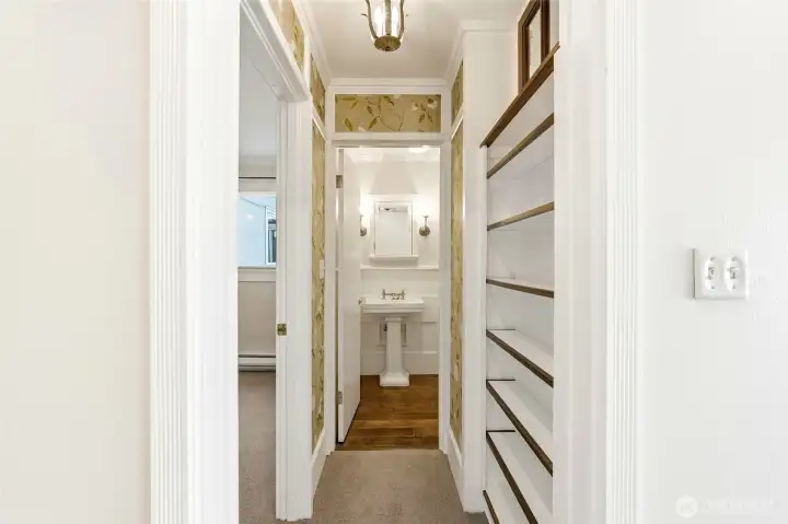 Thoughtful built-ins and charming lighting enhance this inviting hallway.