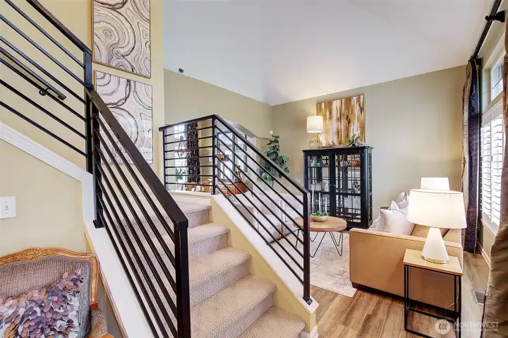 Inside, the home showcases a classic Pacific NW floor plan with an open living and dining room featuring vaulted ceilings.  New iron handrails and LVP flooring have also been added.