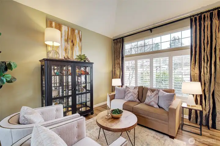 High ceilings with tall windows finished with glossy white shutters add to the ambiance of this home.
