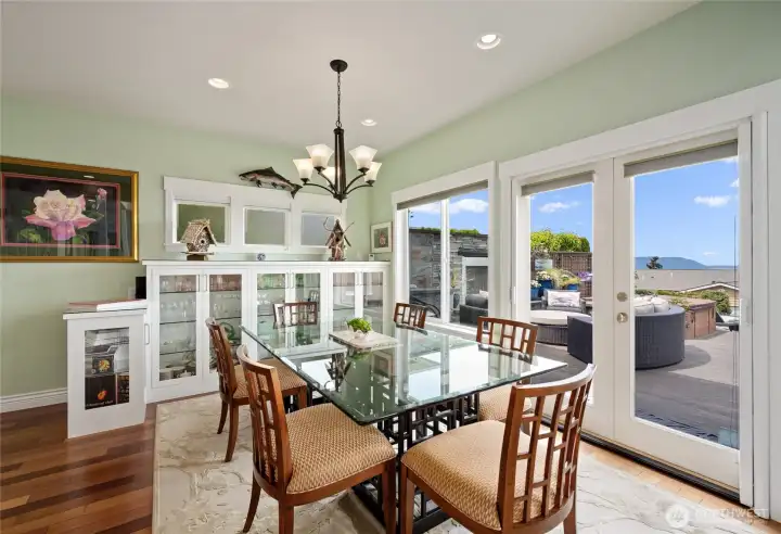 Beautiful dining room with built-in China cabinet, French doors leading to an amazing outdoor extension of living. Beautiful dining room with built-in China cabinet, French doors leading to an amazing outdoor extension of living.