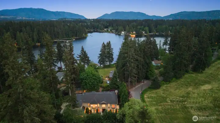 Abundant views of Pine Lake are captured throughout the property, creating a constant connection to the water and surrounding natural beauty. From main living areas to private retreats, expansive windows and thoughtful sightlines ensure the lake remains a defining backdrop in every season.    Whether reflecting morning light across the water or glowing at sunset, Pine Lake becomes an ever-present focal point—framing daily life with a sense of calm and continuity. These sweeping vistas elevate the home’s atmosphere, blending indoor elegance with the serene landscape just beyond, and reinforcing a true northwest lifestyle experience.