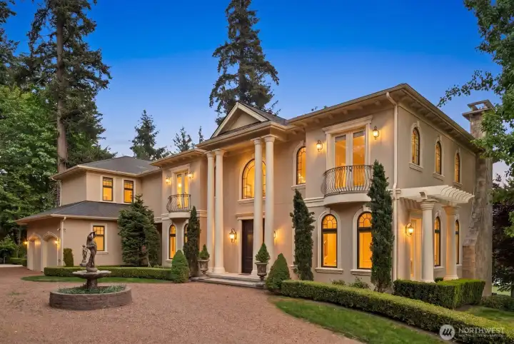 Arriving at this Mediterranean-inspired villa at the end of the day, the experience immediately shifts from the outside world to a sense of calm and retreat. Architectural presence, warm detailing, and thoughtfully layered design elements set a welcoming tone before you even step inside.    As you enter, the atmosphere unfolds into light-filled interiors, open gathering spaces, and sweeping lake views that naturally quiet the pace of the day. The transition from arrival to relaxation is seamless—each space designed to soften stress and restore a sense of ease within a private, elevated setting.