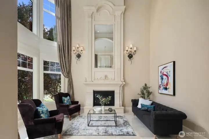 An extraordinary two-story fireplace serves as a dramatic architectural centerpiece, carrying the home’s elegance and refinement throughout every level. Rising with sculptural presence, it anchors the main living space while drawing the eye upward, emphasizing the soaring ceilings and grand scale of the design.    Clad in carefully selected materials that echo the home’s Mediterranean influence, the fireplace blends warmth and artistry—offering both visual impact and a sense of intimate comfort. Whether viewed from the main floor or the upper level, it creates a continuous thread of sophistication, tying together the home’s open-concept flow with timeless character.    More than a focal point, it becomes an experience—radiating warmth, ambiance, and architectural distinction that elevates everyday living into something truly memorable.