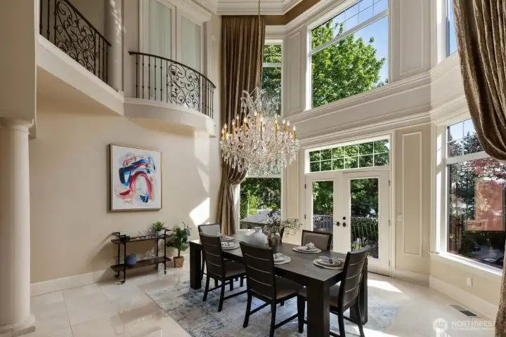 A Juliette balcony off the primary suite captures elevated lake views, creating a private vantage point overlooking the home’s most striking features below. From this serene perch, sightlines extend across the formal dining room and the showstopping two-story fireplace, reinforcing the home’s architectural drama and cohesive design.