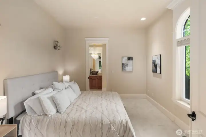 A main floor bedroom offers added convenience and flexibility, featuring its own full bathroom and a nearby exterior door just outside the room. This configuration is well-suited for guests, multigenerational living, or private office use, providing both accessibility and separation from the primary living areas.