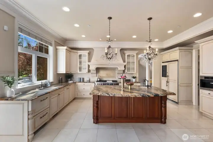 The gourmet kitchen is designed for both function and elevated entertaining, featuring a spacious walk-in pantry for exceptional storage and organization. Granite countertops provide a durable yet refined workspace, while a drawer-style dishwasher adds convenience and a streamlined aesthetic to the layout.    Thoughtful detailing and quality finishes throughout create a kitchen that is as practical for everyday living as it is well-suited for hosting and culinary gatherings.