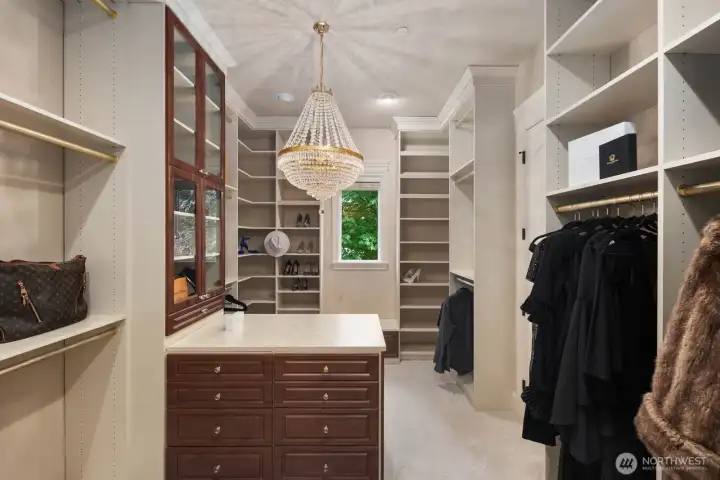 The primary suite walk-in closet is thoughtfully designed with tailored organization and refined finishes, offering an elegant space to store and display wardrobes with ease. Custom layout and attention to detail create a functional yet elevated environment that complements the sophistication of the primary retreat.