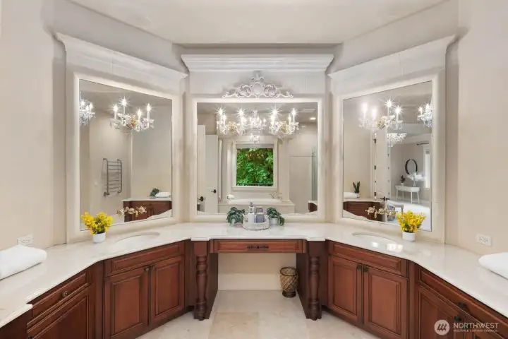 The spacious primary ensuite is designed as a serene, spa-inspired retreat, featuring a walk-in shower, a generously sized soaking tub positioned to take in tranquil lake views, and expansive countertop space with dual functionality for daily routines. The layout balances comfort and practicality, offering a calming, well-appointed environment to begin and end each day.