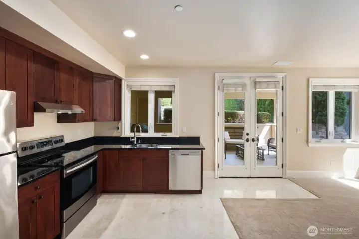 The lower level offers exceptional versatility with a second kitchen and flexible living space that can function as a private one-bedroom suite, ideal for multigenerational living or guest accommodations. This area provides separation from the main level while maintaining convenient interior access.    Buyer to verify all permitted use, ADU classification, and any applicable requirements with the appropriate jurisdiction.