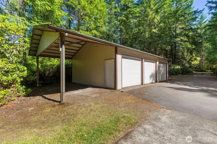 Three car detached garage/shop w carport.