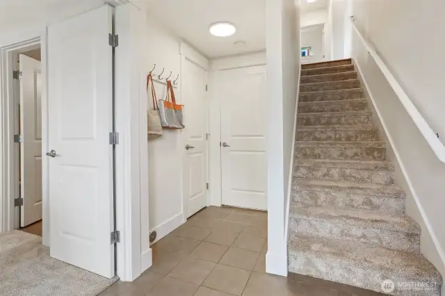 Door to the left of the stairs leads to the garage.