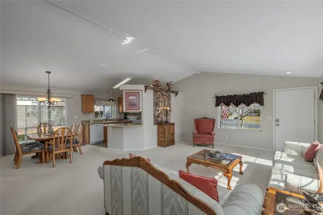 open living, dining and kitchen area with slider to covered patio