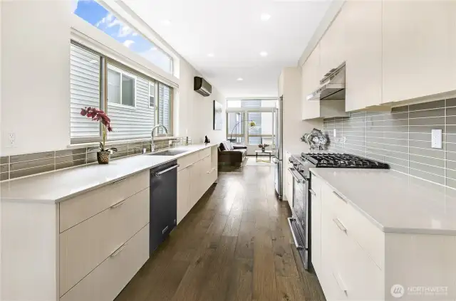 Awesome kitchen a six-burner gas stove, stainless refrigerator with French doors and bottom freezer. Beautiful wood floors throughout.