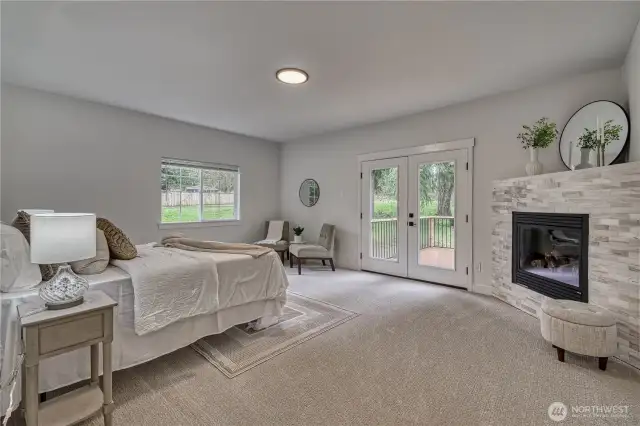 The stunning primary suite with a fireplace and private deck.