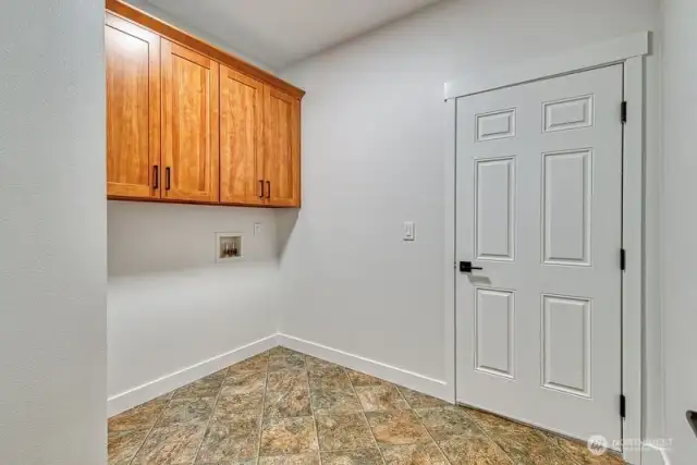 The spacious utility room the leads to the garage.