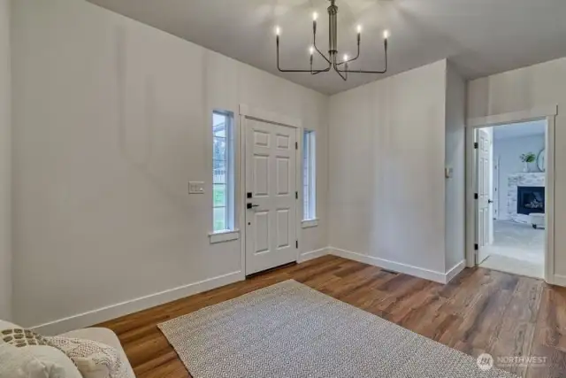 The door on the right goes to the luxurious primary suite, separate from the other three bedrooms.