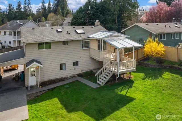 Back of the home shows open carport and covered deck