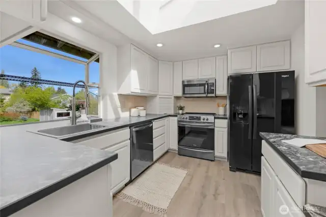 Fresh updates to kitchen include: new countertops, appliances and flooring