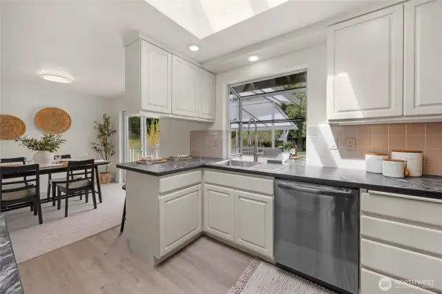 Fresh updates to kitchen include: new countertops, appliances and flooring