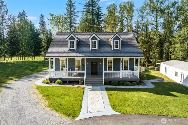 Extra parking to the west of the home!  You'll love the porch swing or sitting with morning coffee.