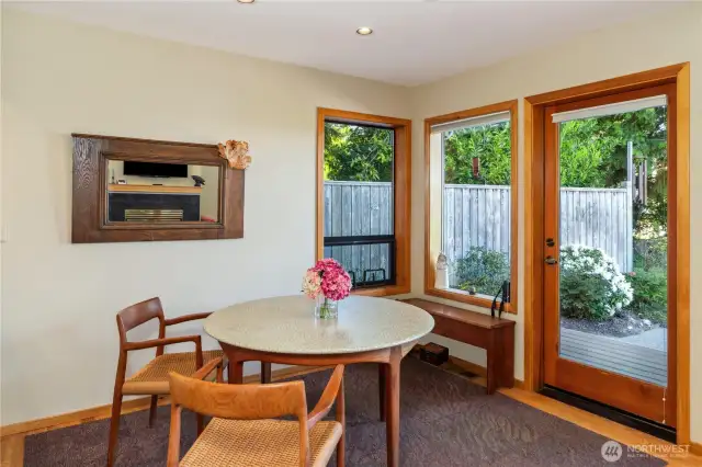 The dining area easily holds four chairs, two are being recovered so not in the photo. The door leads to the sunny and spacious flat patio.