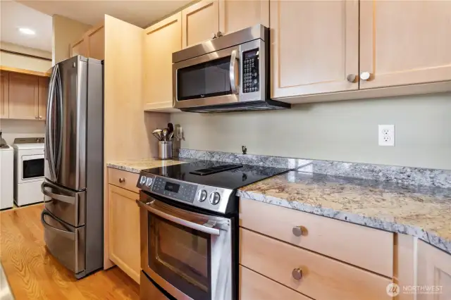 Ample counter space, wonderful stainless steel appliances, hardwood floors, generous amounts of cabinetry and real wood floors makes this functional kitchen shine!