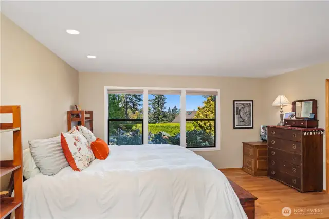 The primary bedroom is spacious and also has hardwood floors. Up-Down curtains give you privacy and light at all times of the day.
