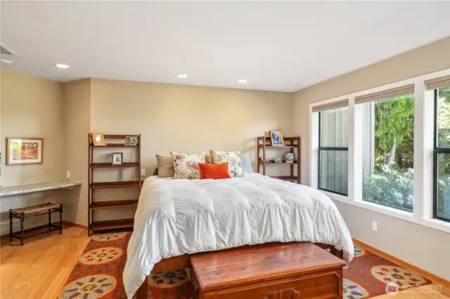 The primary bedroom easily fits this king-size bed. Note the built-in desk space on the left. Up-down blinds give you privacy and light when you want one or the other.