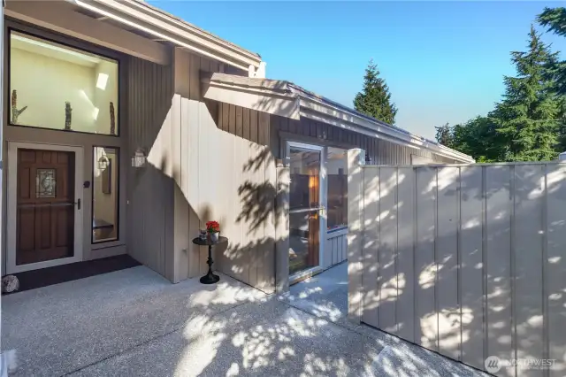 View of the front door, and access to the private, gated courtyard that has access to the guest bedroom that doubles as a den or craft room.