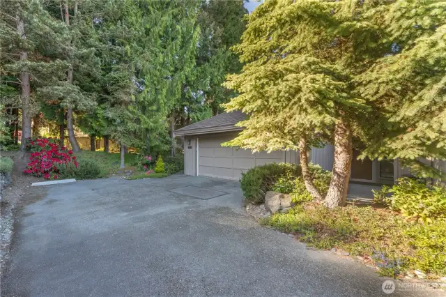 The back entrance to the condo leads to the two-car garage and lovely setting.