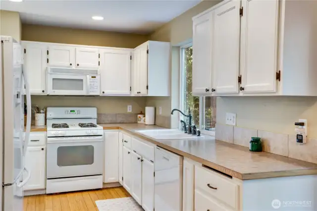 Enjoy scenic backyard views while preparing a delicious meal or cleaning up after one. The laminate counters and tile backsplash make for easy maintenance!