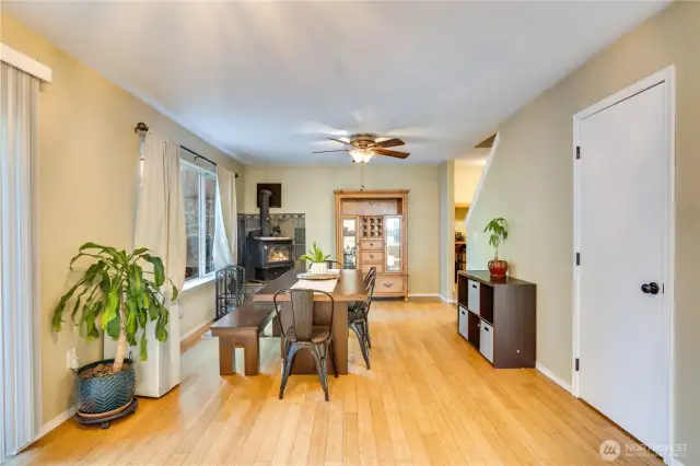 While currently used as a dining room, this could also function as a family room with the woodstove ready to go for the upcoming fall and winter months! There is also a half bath behind the door to the right, and the oversized sliding glass door to the backyard and deck is to the left.