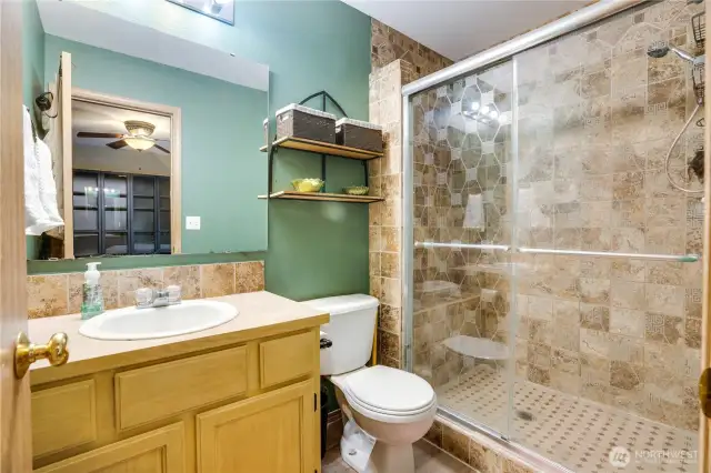 The primary bathroom is sure to please with the oversized shower with tile surround, large vanity, and newer paint!