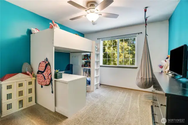 Bedroom two upstairs is a generous size and features a ceiling fan to keep cool, as well as fun blue accent walls.