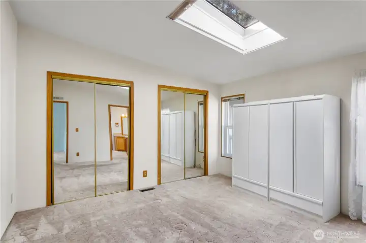 Primary suiet has mirrored closet doors, and looks out to the masive driveway.  The skylight has a shade to close for the day sleepers.
