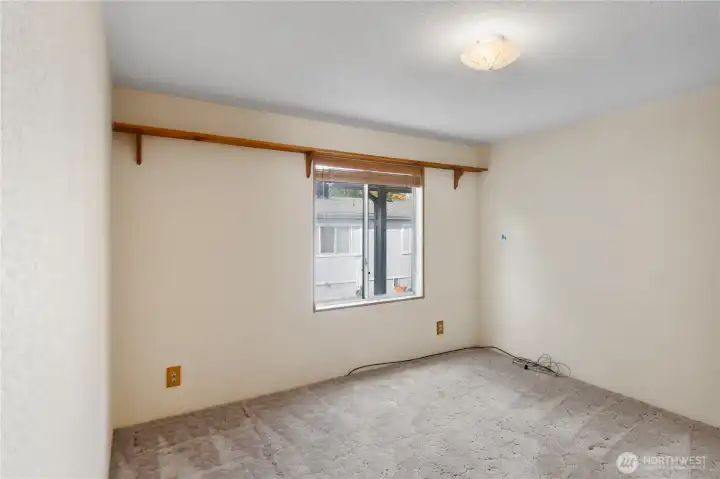Bedroom #3 looks out to the driveway and double car garage.