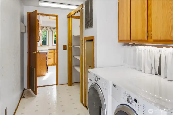 The laundry room has plenty of storage, and great access to the kitchen.