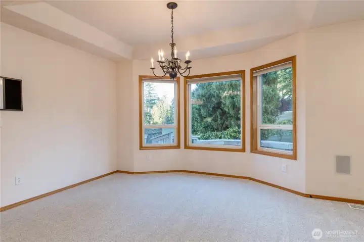 The newly carpeted living room has bay windows; the home is a true custom-built home.