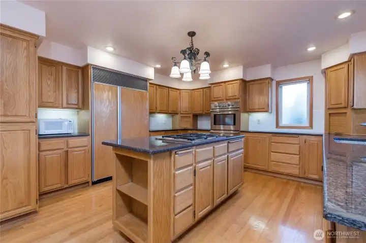 There are expansive oak cabinets for storage and access throughout the kitchen areas