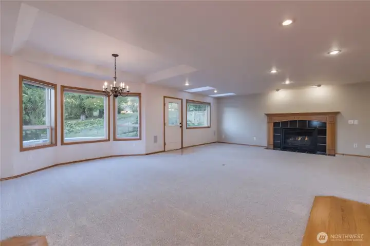 The expansive family room is adjacent to the kitchen, and has a dining areas well as a gas fireplace and direct access to the backyard and backyard decks.  There is also recessed can lighting and skylights
