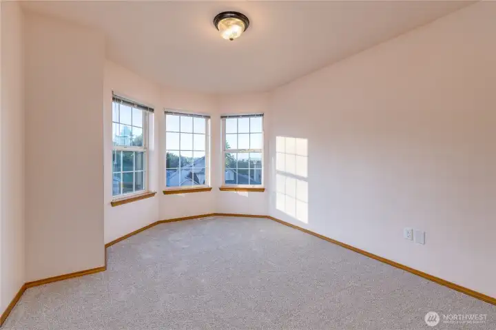 The bay windows in a primary bedroom suite