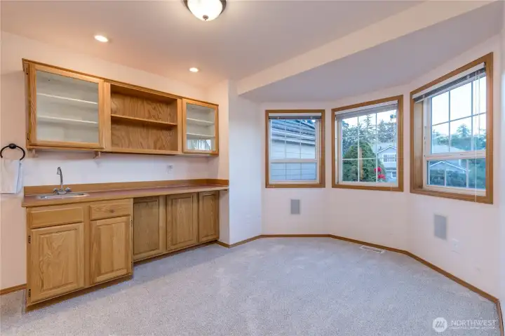 An office, lounge, library or entertaining area, with a wet bar and bay windows