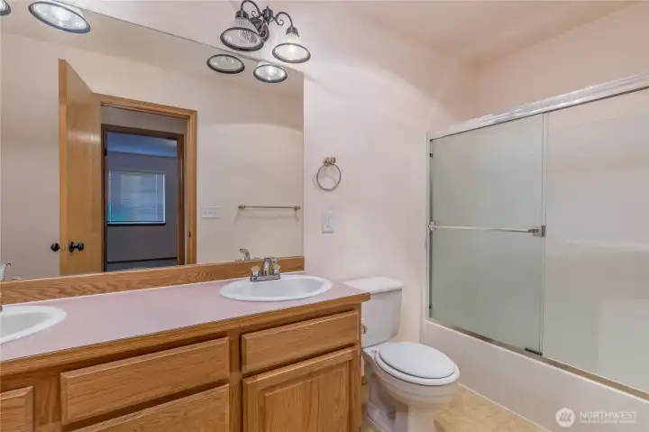The main bathroom has dual sinks and upgraded lighting