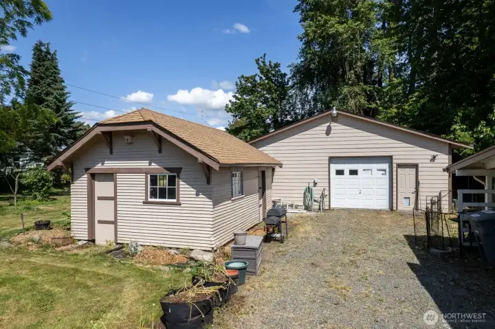 960 sqft garage on the left, with garage doors on two sides. On the left is a storage shed.