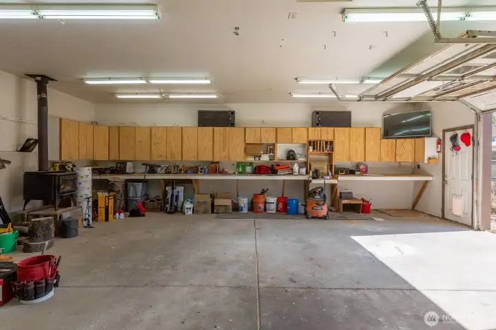 Tons of storage cabinet space in the garage, PLUS a wood stove.