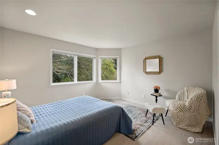 Primary bedroom with a view to the trees