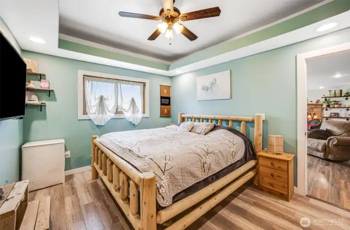 Primary Bedroom featuring tray ceilings
