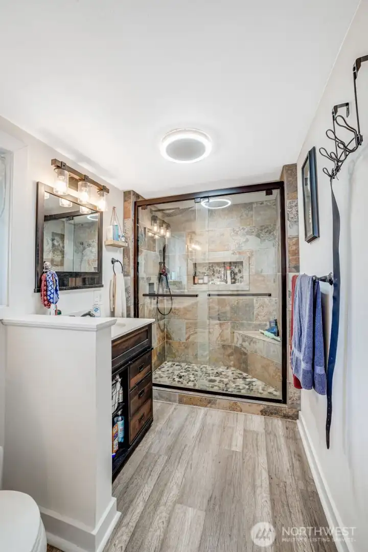 Custom Tiled walk in shower with build in shelving and glass shower doors