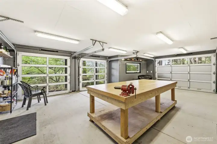 Workshop features full roll-up doors for a true connection to the outdoors, plus extensive storage running the full length of the home.