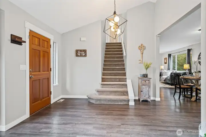 New carpeting on stairwell. Notice the vaulted ceiling and a peek to the right show the dining area and living room.